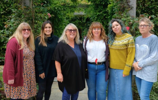 Southdown's Pathways Home team are standing outside and are smiling at the camera.