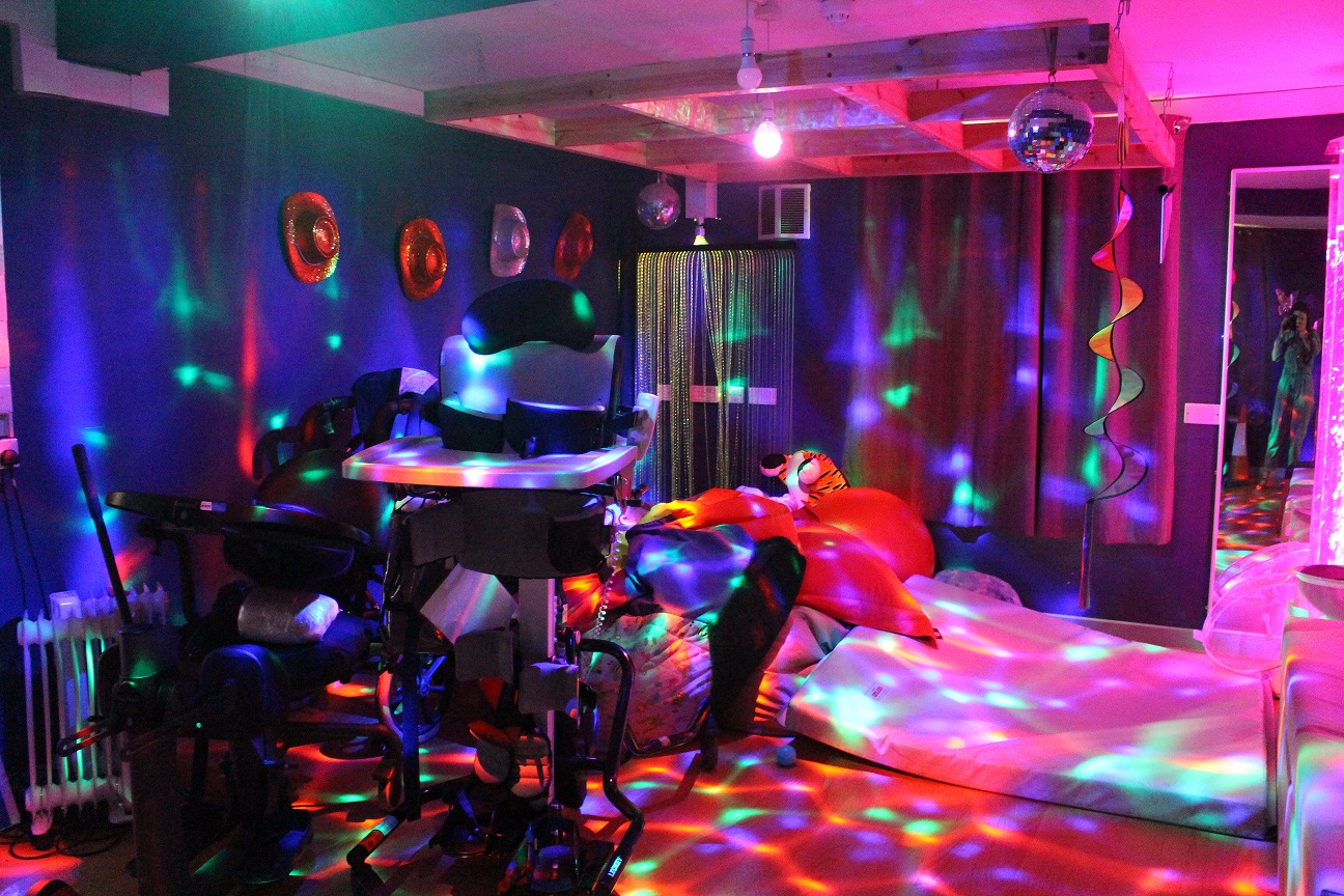 A dark room filled with bright, sparkly, coloured lights