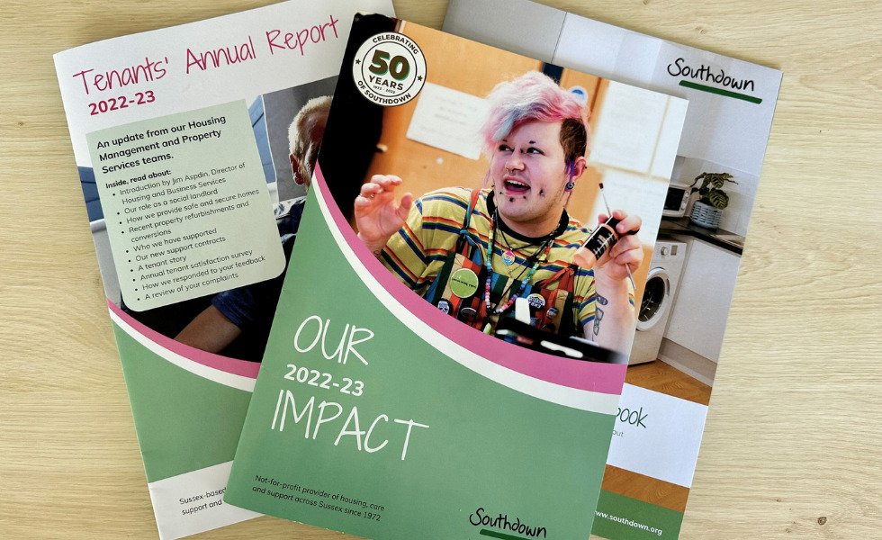 On a table there are three copies of Southdown's recent reports. The text reads: - Our Impact Report 2022-23 -Tenant's Annual Report