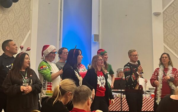 Southdown staff singing Christmas carols at Learning Disability service annual carol concert.