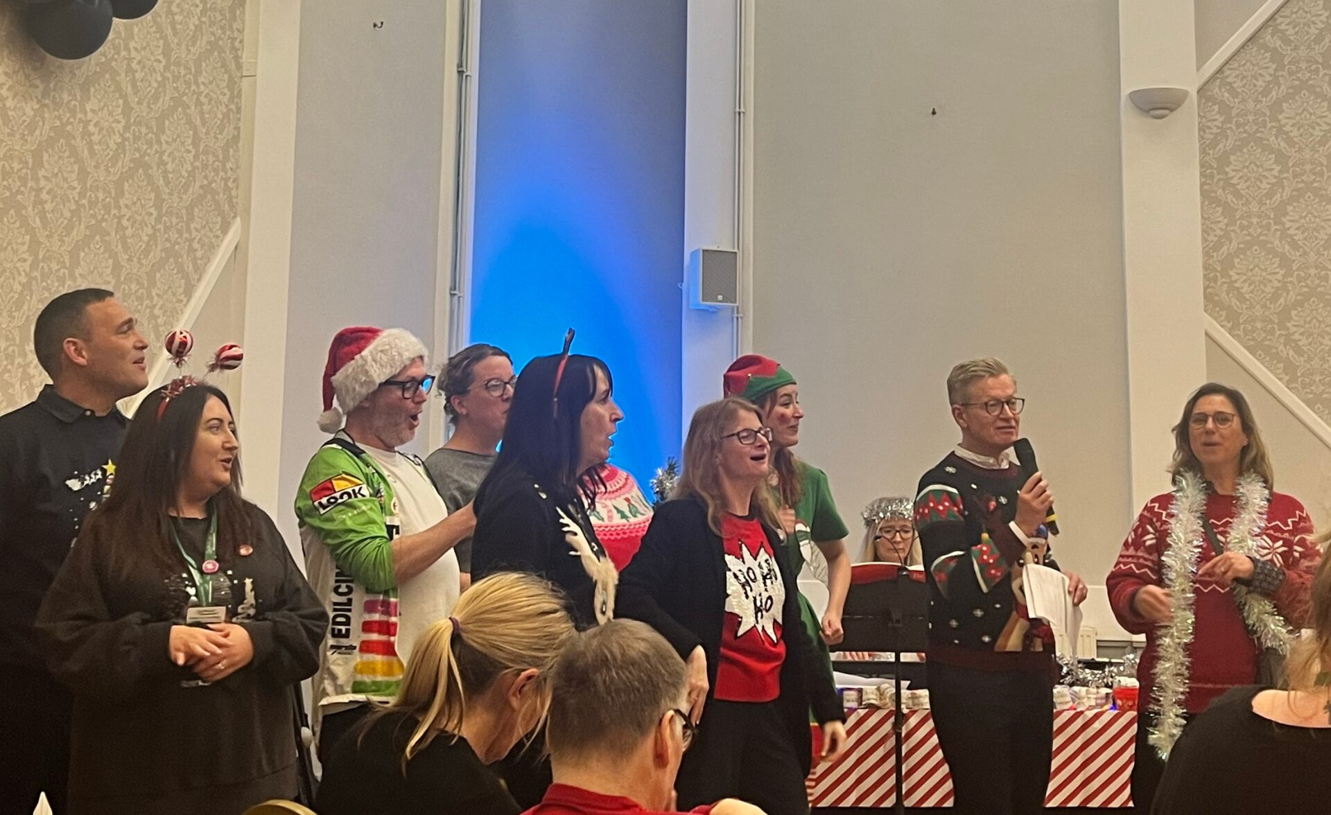 Southdown staff singing Christmas carols at Learning Disability service annual carol concert.